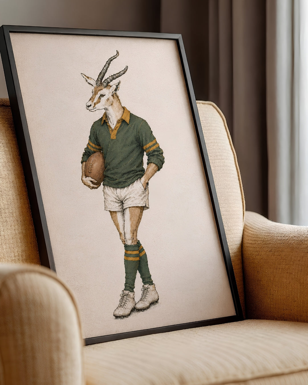 A framed art print featuring a whimsical illustration of a gazelle dressed in vintage rugby attire, leaning against a beige armchair in a cozy room setting.