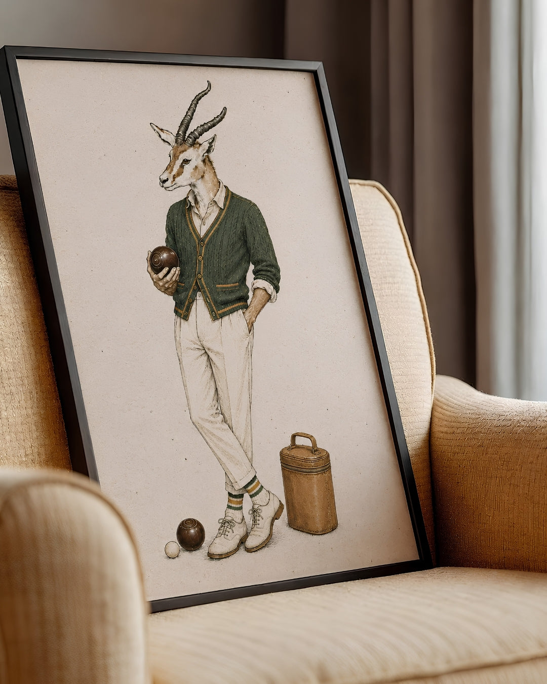 A framed art print featuring a whimsical illustration of a gazelle dressed in vintage menswear playing croquet, leaning against a beige armchair in a cozy room setting.